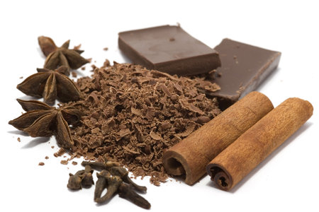 "Grated chocolate with cinnamon, anise, cloves and blocks of chocolate isolated on white"の写真素材