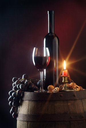 Still life with red wine and candleの写真素材