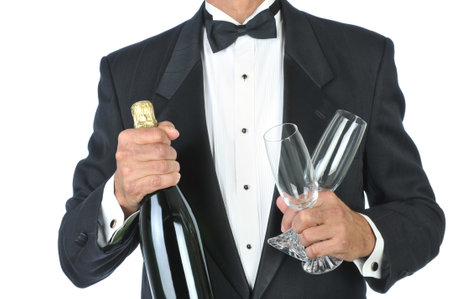Man Wearing Tuxedo Holding Champagne Bottle and Glasses torso only isolated on whiteの写真素材