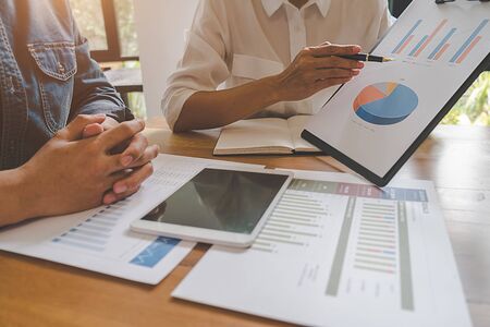 Business team brainstorming and discussing with financial data and report graph. Teamwork meeting working concept.の写真素材