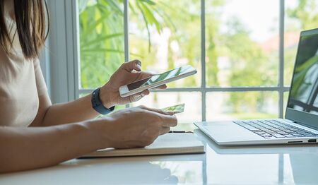 Happy asian woman doing online shopping at home. Online payment and shopping concept.