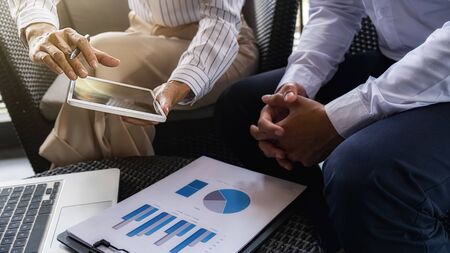 Business team brainstorming and discussing with financial data and report graph. Teamwork meeting working concept.の写真素材