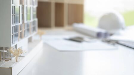 Engineering or Architect tools, blueprint and building model on table in office. Construction...