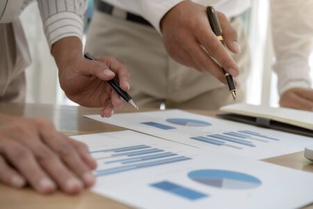 Business team brainstorming and discussing with financial data and report graph. Teamwork meeting...