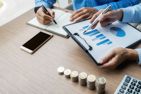 Business Finance and Saving Concept. Business team brainstorming and discussing with financial data and report graph.の写真素材