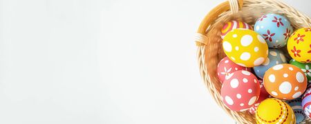 Easter eggs in the basket on white desk. Happy Easter day.の写真素材