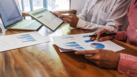 Business team brainstorming and discussing with financial data and report graph. Teamwork meeting working concept.の写真素材