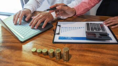 Business Finance and Saving Concept. Business team brainstorming and discussing with financial data...