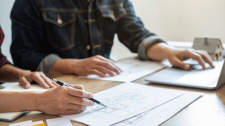 Interior designer and Architect choosing color in color swatch samples chart for house coloring selection in office with blueprint. Construction concept.の写真素材
