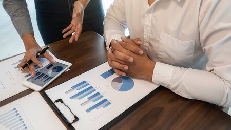 Business team brainstorming and discussing with financial data and report graph. Teamwork meeting working concept.の写真素材