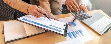 Business team brainstorming and discussing with financial data and report graph. Teamwork meeting...