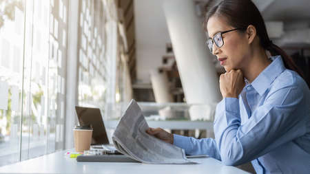 Young unemployed is searching for a job in the newspaper and laptop. Interview the job and hiring...