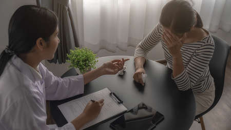 Psychiatrist or professional psychologist consulting on diagnostic examination disease or mental illness in medical clinic or hospital mental. Medical and Healthy service concept.の写真素材