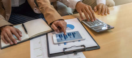 Business team brainstorming and discussing with financial data and report graph. Teamwork meeting...