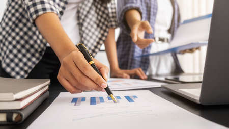 Business team brainstorming and discussing with financial data and report graph. Teamwork meeting...