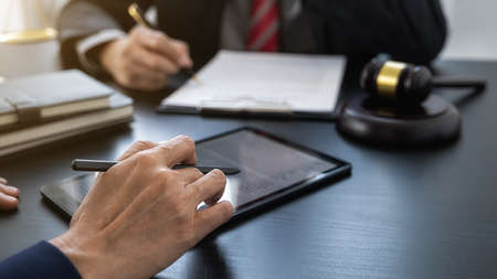 Professional lawyer advising a client on commercial contract legal in service office. Justice, Law, Attorney and Court judge concept.の写真素材