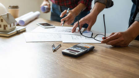 Interior designer and Architect choosing color in color swatch samples chart for house coloring selection in office with blueprint. Construction concept.の写真素材
