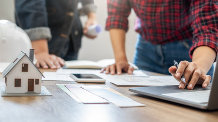 Interior designer and Architect choosing color in color swatch samples chart for house coloring selection in office with blueprint. Construction concept.の写真素材