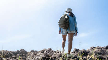 Hipster Asian woman hiking in mountain, wild adventure. Adventure Travel Concept.