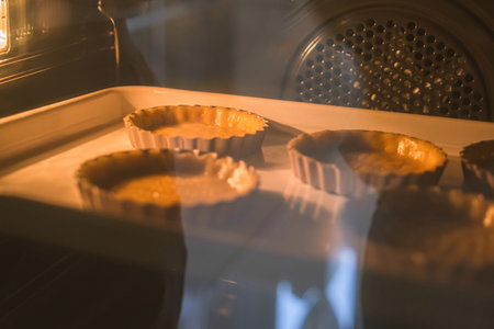 Freshly baked tartlets in the oven. Selective focus. Toned.の写真素材