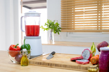 Counter in kitchen at home with blender, vegetables, fruits for making smoothie for drinking for better living and wellbeing. Healthy wellbeing concept.の写真素材