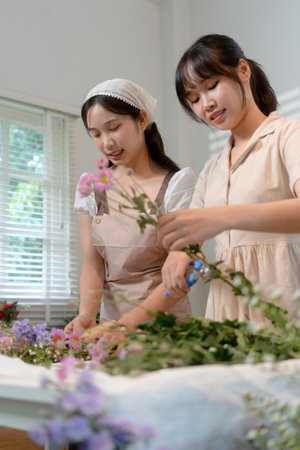 Gardeners florist at her own floral shop taking care of flowers.の写真素材