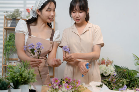 Gardeners florist at her own floral shop taking care of flowers.