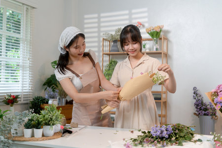 Gardeners florist at her own floral shop taking care of flowers.の写真素材
