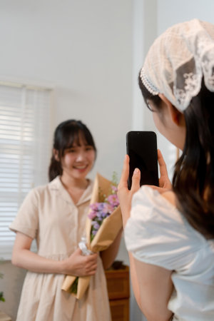 Gardeners florist at her own floral shop taking care of flowers.の写真素材
