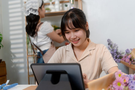 Gardeners florist at her own floral shop taking care of flowers.の写真素材