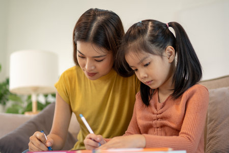 Lovely mom and little young daughter spending time together in their living room.の写真素材
