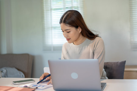 Lovely mom and little young daughter spending time together in their living room.の写真素材