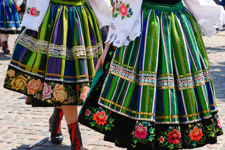 Regional, folklore costumes, colorful handmade skirts with stripes and symbols embroidered. During Corpus Christi parade.の写真素材