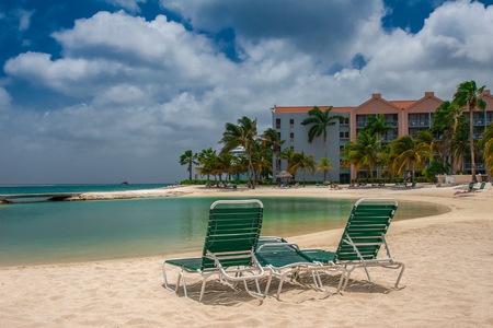 ORANJESTAD, ARUBA - October 12.2007: View on the sun bed on the sandy beach and turquoise sea in the hotel resort.のeditorial素材