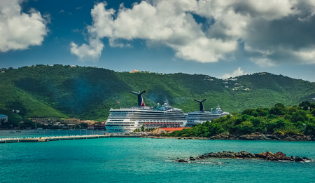 Saint Thomas / US Virgin Islands - October 31.2007: View on the back of cruise ships docked in Charlotte Amalie port. Blue sky with clouds, sunny day, turquoise color sea, green hills around.のeditorial素材