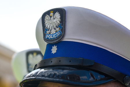 Police hat with polish emblem of white eagle and police sign.の写真素材
