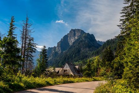 View on the mountain with wooden shack located under on the meadow.の写真素材