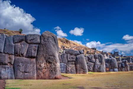 Sacsayhuaman ruins in Cusco, Peru. A monumental complex of stone buildings made by Incas. Pre Columbian megalithic fortified constructions often visited by tourists.の写真素材