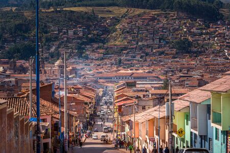 Cusco / Peru - May 27.2008: View on the city street leading up the hill during sunny day. Local architecture of the houses with orange color roofs on the street. Blue sky and clouds.のeditorial素材