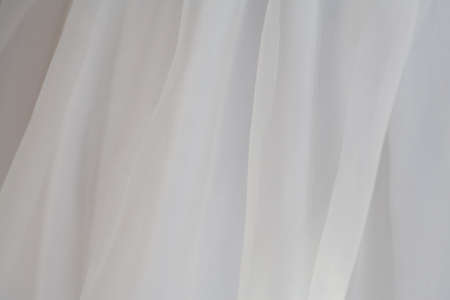 sheer white draped fabric macro background, selective focus, close-up, layered, full frameの写真素材