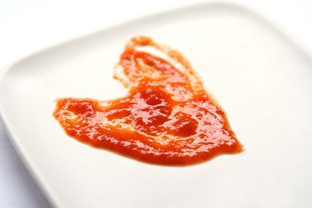 This heart shape was formed from Chilli sauce served on a plate. Add new meaning to HOT SPICY love!の写真素材
