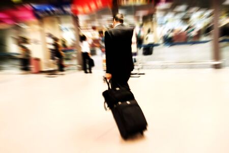 Business man rushing at the airport. Intentional Zoom-effect motion blur.の写真素材