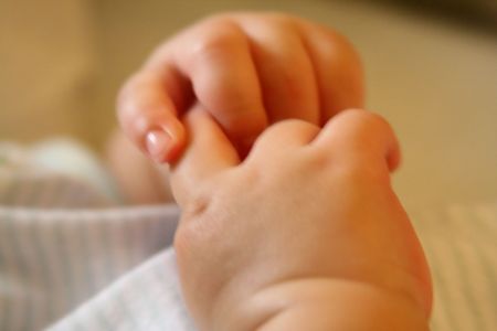 Baby hands playing. intentional shallow DOF. Slight motion blur.