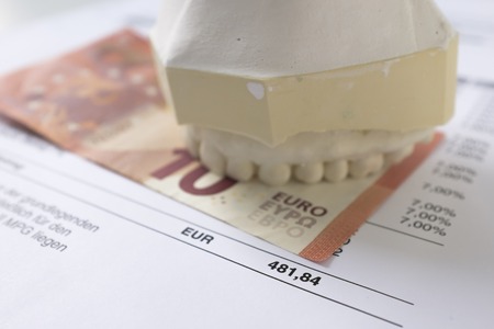 A gypsum dental impression on a banknote and dentistryの写真素材