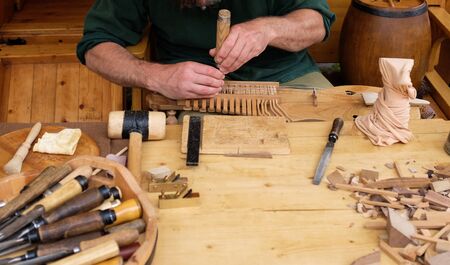 An instrument maker in making wooden musical instrumentsの写真素材