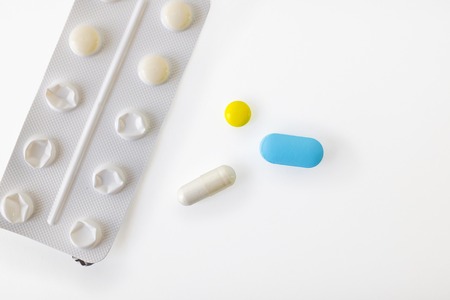 Several different pills types on white background