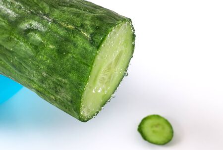 A sliced, freshly washed cucumber with water dropletsの写真素材
