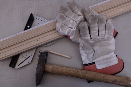 Tool still life with work gloves with angle bar and skirting boardの写真素材