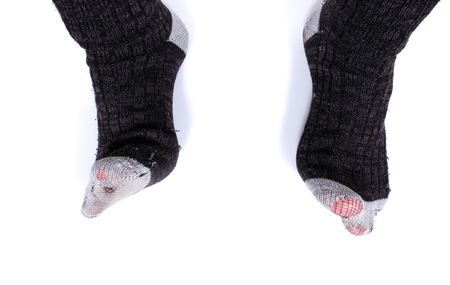 Detail of feet with torn socks (poverty)の写真素材