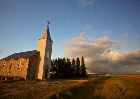 Thunderhead clouds forming behind a country churchの写真素材